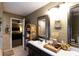 Well-lit bathroom featuring double mirrors, a stylish white sink, and attractive decor at 184 Wildflower Dr, Social Circle, GA 30025