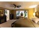 Bright primary bedroom featuring an electric fireplace, large bed, and vanity near the window at 184 Wildflower Dr, Social Circle, GA 30025
