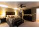 Spacious primary bedroom features a ceiling fan, large bed, and media center at 184 Wildflower Dr, Social Circle, GA 30025