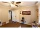 Bedroom with wall paneling, neutral carpet flooring, ceiling fan, and decorated walls at 184 Wildflower Dr, Social Circle, GA 30025