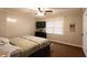 Comfortable bedroom features paneled walls, a ceiling fan, and natural light from the window at 184 Wildflower Dr, Social Circle, GA 30025