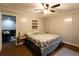 Comfortable bedroom view features paneled walls, a ceiling fan, and access to the living room at 184 Wildflower Dr, Social Circle, GA 30025