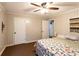 Comfortable bedroom features paneled walls, a ceiling fan, and easy access to closets at 184 Wildflower Dr, Social Circle, GA 30025