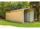 Tan metal carport for vehicle parking or storage in backyard at 184 Wildflower Dr, Social Circle, GA 30025