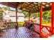 Outdoor deck with wooden floor, seating, and view of the yard at 184 Wildflower Dr, Social Circle, GA 30025