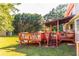 Inviting wooden deck featuring a covered area and string lights, perfect for outdoor entertaining at 184 Wildflower Dr, Social Circle, GA 30025
