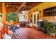 Cozy outdoor deck with ceiling fans, seating, grill, and plants at 184 Wildflower Dr, Social Circle, GA 30025
