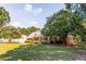 Charming brick home surrounded by lush greenery and a spacious lawn at 184 Wildflower Dr, Social Circle, GA 30025
