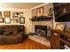 Elegant fireplace with brick surround, mantle decor, and hardwood flooring at 184 Wildflower Dr, Social Circle, GA 30025