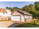 Detached garage with a white door, concrete driveway, and wooden fence at 184 Wildflower Dr, Social Circle, GA 30025