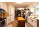 Bright kitchen featuring white cabinetry, stainless steel appliances, and center island at 184 Wildflower Dr, Social Circle, GA 30025