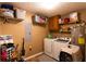 Functional laundry area with washer, dryer, and ample storage shelves at 184 Wildflower Dr, Social Circle, GA 30025