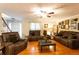 Cozy living room with hardwood floors, comfortable sofas, and staircase at 184 Wildflower Dr, Social Circle, GA 30025