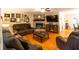 Spacious living room featuring hardwood floors, brick fireplace, and comfortable seating at 184 Wildflower Dr, Social Circle, GA 30025