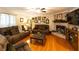 Inviting living room with a brick fireplace, hardwood floors, and stylish decor at 184 Wildflower Dr, Social Circle, GA 30025