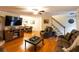 Large living room featuring hardwood floors, TV, and stairs to the upper level at 184 Wildflower Dr, Social Circle, GA 30025