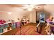 Spacious playroom view featuring vaulted ceilings, ceiling fan, and lots of storage at 184 Wildflower Dr, Social Circle, GA 30025