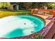 Backyard with above-ground pool and wooden deck with seating and sport equipment at 184 Wildflower Dr, Social Circle, GA 30025