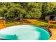 Backyard with above-ground pool surrounded by a grassy yard and mature trees at 184 Wildflower Dr, Social Circle, GA 30025
