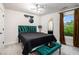Inviting bedroom with lush green velvet accents, plush carpeting, and ample natural light at 76 Mayson Avenue Northeast Ne, Atlanta, GA 30307