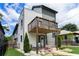 Contemporary two-story home with a wooden balcony, small front patio, and well-maintained lawn at 76 Mayson Avenue Northeast Ne, Atlanta, GA 30307