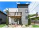Modern two-story home featuring mixed siding, a wooden balcony, and professionally landscaped yard at 76 Mayson Avenue Northeast Ne, Atlanta, GA 30307