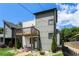 Modern two-story home featuring mixed siding, a wooden balcony, and professionally landscaped yard at 76 Mayson Avenue Northeast Ne, Atlanta, GA 30307
