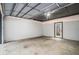 Spacious two-car garage with concrete floor and access door to backyard at 76 Mayson Avenue Northeast Ne, Atlanta, GA 30307