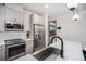 Bright kitchen with a stainless sink, appliances, and modern cabinetry; open to the back door at 76 Mayson Avenue Northeast Ne, Atlanta, GA 30307