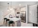 Well-lit kitchen featuring a quartz countertop island, modern appliances, and stylish pendant lighting at 76 Mayson Avenue Northeast Ne, Atlanta, GA 30307