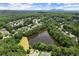 Aerial view of the community lake surrounded by lush greenery and beautiful homes at 956 Kinghorn Nw Dr, Kennesaw, GA 30152