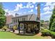 View of backyard with patio dining, outdoor kitchen, and well-manicured lawn at 956 Kinghorn Nw Dr, Kennesaw, GA 30152