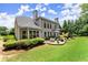 Beautifully landscaped backyard with a patio, outdoor seating, and lush lawn at 956 Kinghorn Nw Dr, Kennesaw, GA 30152