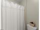 Bathroom with a white shower curtain and a toilet, providing a clean and simple space at 956 Kinghorn Nw Dr, Kennesaw, GA 30152