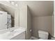 Bathroom featuring white vanity, toilet, and shower with a white curtain at 956 Kinghorn Nw Dr, Kennesaw, GA 30152