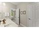 Bright bathroom with a double sink vanity, and view to bedroom at 956 Kinghorn Nw Dr, Kennesaw, GA 30152