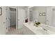 Bright bathroom features a double vanity and view to adjacent bathroom at 956 Kinghorn Nw Dr, Kennesaw, GA 30152