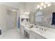 Bright bathroom featuring double sinks, white cabinetry, and a soaking tub at 956 Kinghorn Nw Dr, Kennesaw, GA 30152