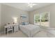 Cozy bedroom with a writing desk, natural light, and a ceiling fan at 956 Kinghorn Nw Dr, Kennesaw, GA 30152