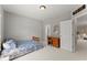 Cozy bedroom boasts a single bed, desk, and doorway to the upper level at 956 Kinghorn Nw Dr, Kennesaw, GA 30152