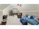 Bright bonus room with blue sofa, game table, and carpeting at 956 Kinghorn Nw Dr, Kennesaw, GA 30152