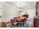 Elegant dining room with large windows, chandelier, and traditional furnishings at 956 Kinghorn Nw Dr, Kennesaw, GA 30152