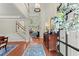 Grand foyer with high ceilings, hardwood floors, staircase, and natural light streaming through transom windows at 956 Kinghorn Nw Dr, Kennesaw, GA 30152