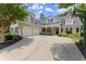 Traditional brick home with a manicured lawn, two-car garage, and charming covered front porch at 956 Kinghorn Nw Dr, Kennesaw, GA 30152