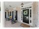 Inviting front porch with rocking chairs, brick flooring and a beautiful front door with floral wreath at 956 Kinghorn Nw Dr, Kennesaw, GA 30152