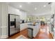 Bright kitchen features stainless steel appliances, a central island, and an eat-in breakfast nook at 956 Kinghorn Nw Dr, Kennesaw, GA 30152
