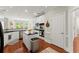 Bright kitchen with white cabinets, stainless steel appliances, and a functional island at 956 Kinghorn Nw Dr, Kennesaw, GA 30152