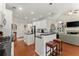 Well-lit kitchen boasting white cabinets, granite countertops, stainless steel appliances, and a cozy breakfast bar at 956 Kinghorn Nw Dr, Kennesaw, GA 30152