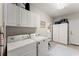 Well-equipped laundry room with washer, dryer, and plenty of cabinet space at 956 Kinghorn Nw Dr, Kennesaw, GA 30152