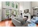 Sun-drenched living room featuring tall windows, fireplace, and refined decor at 956 Kinghorn Nw Dr, Kennesaw, GA 30152